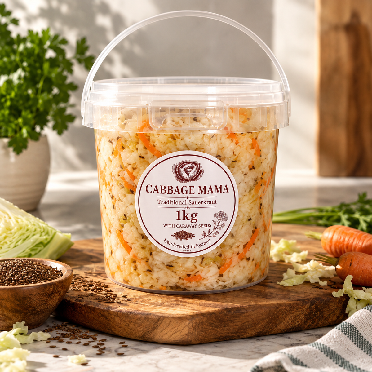 Cabbage Mama 1kg traditional sauerkraut with carrots and caraway seeds in a clear tub.