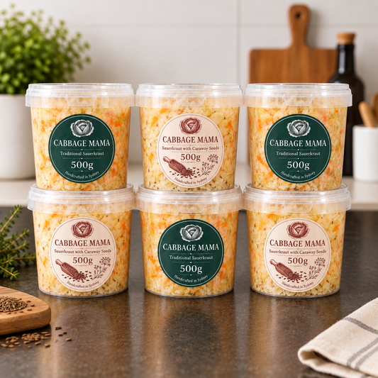 Cabbage Mama Big Family Pack 3kg with six 500g tubs of sauerkraut, including Traditional and Caraway Seeds varieties, displayed on a kitchen bench.