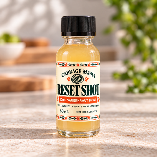 Cabbage Mama Reset Shot 60mL bottle of raw unpasteurised sauerkraut brine with live cultures on a kitchen bench.